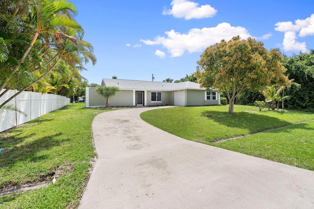 2307 SE Seafury Ln SE, Port Saint Lucie, FL 34952 - ranch-style house featuring driveway, a garage, and stucco siding