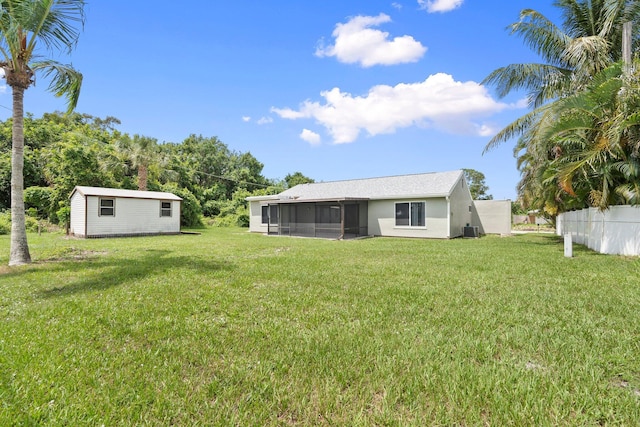 2307 SE Seafury Ln SE, Port Saint Lucie, FL 34952 - view of yard with a sunroom, an outbuilding, and central AC