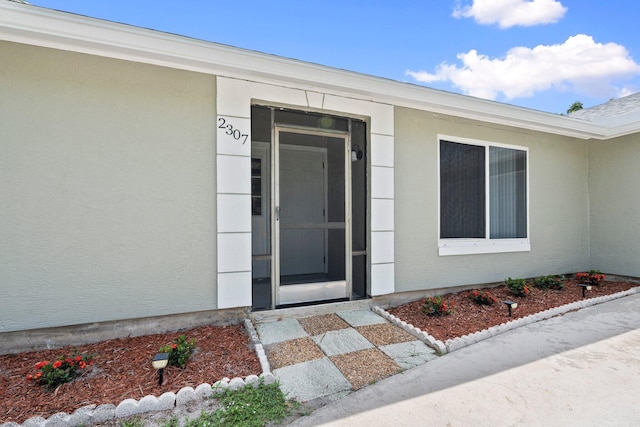 2307 SE Seafury Ln SE, Port Saint Lucie, FL 34952 - view of exterior entry with stucco siding