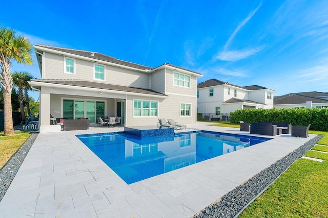983 Hookline Cir, The Acreage, FL 33470 - rear view of house featuring outdoor lounge area and a patio