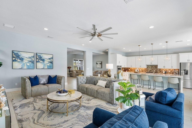 983 Hookline Cir, The Acreage, FL 33470 - living room with ceiling fan, recessed lighting, and a textured ceiling
