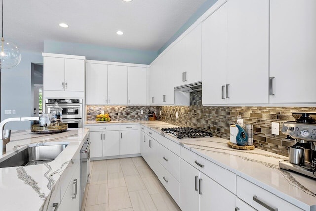 983 Hookline Cir, The Acreage, FL 33470 - kitchen featuring a sink, appliances with stainless steel finishes, tasteful backsplash, light stone countertops, and recessed lighting