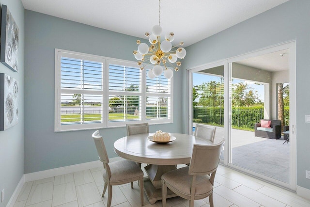 983 Hookline Cir, The Acreage, FL 33470 - dining room featuring plenty of natural light, a chandelier, and baseboards
