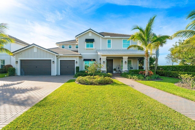 983 Hookline Cir, The Acreage, FL 33470 - view of front of home featuring an attached garage, decorative driveway, board and batten siding, a porch, and a front yard