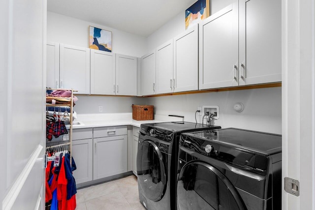 983 Hookline Cir, The Acreage, FL 33470 - laundry area with washing machine and dryer, cabinet space, and light tile patterned floors