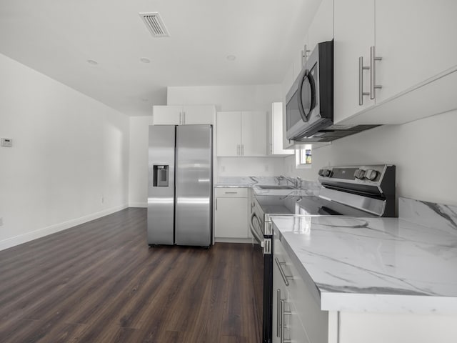 4107 Virginia Ter, West Palm Beach, FL 33405 - kitchen with stainless steel appliances, a sink, light stone countertops, white cabinetry, and dark wood-style flooring