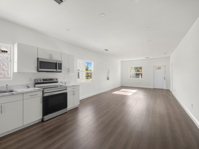 4107 Virginia Ter, West Palm Beach, FL 33405 - kitchen featuring stainless steel appliances, dark wood-style flooring, open floor plan, baseboards, and a sink