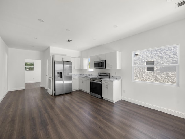 4107 Virginia Ter, West Palm Beach, FL 33405 - kitchen featuring appliances with stainless steel finishes, light countertops, dark wood-style floors, and white cabinetry