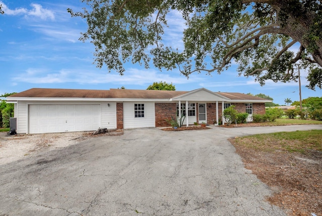 201 Rex Ct, Palm Springs, FL 33461 - ranch-style home featuring an attached garage, brick siding, and driveway