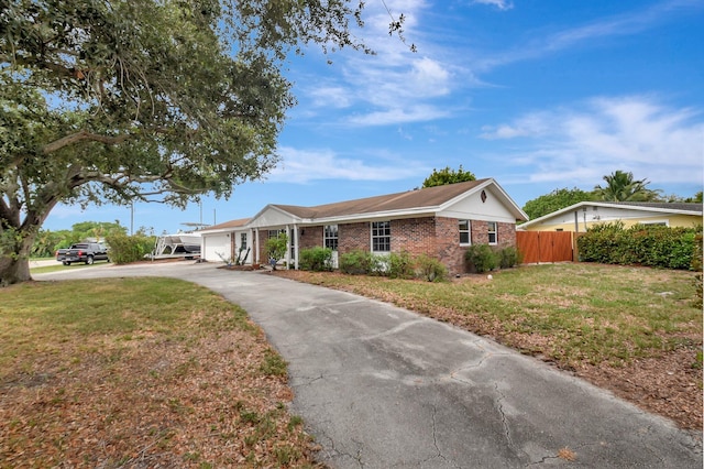 201 Rex Ct, Palm Springs, FL 33461 - ranch-style house featuring a garage, brick siding, and asphalt driveway