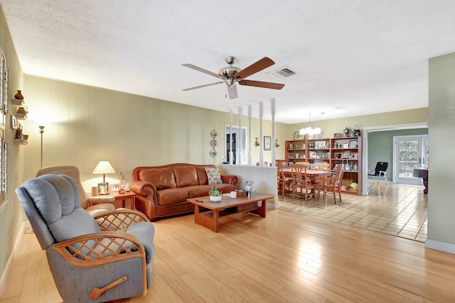 201 Rex Ct, Palm Springs, FL 33461 - living area with a ceiling fan, light wood-style flooring, and a chandelier
