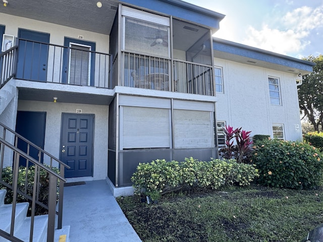 7535 S Orile Blvd Unit 108, Delray Beach, FL 33446 - view of front facade featuring a balcony, stucco siding, and stairs