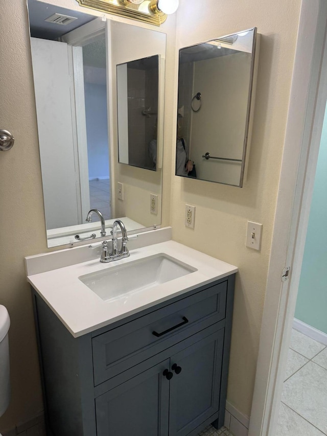 7535 S Orile Blvd Unit 108, Delray Beach, FL 33446 - bathroom featuring vanity, toilet, and tile patterned flooring