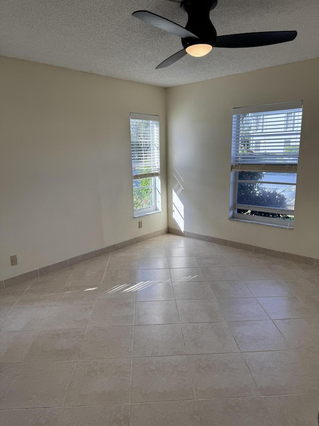 7535 S Orile Blvd Unit 108, Delray Beach, FL 33446 - empty room featuring ceiling fan, tile patterned flooring, a textured ceiling, and baseboards