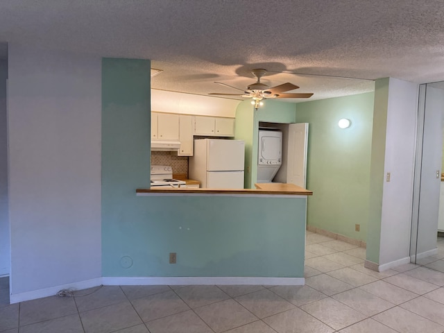 7535 S Orile Blvd Unit 108, Delray Beach, FL 33446 - kitchen featuring white appliances, stacked washer / dryer, under cabinet range hood, ceiling fan, and light tile patterned floors