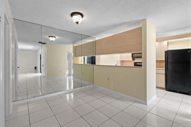 1602 16th Ct Unit 48D, Jupiter, FL 33477 - spare room with light tile patterned flooring, a textured ceiling, and baseboards