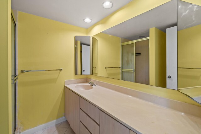 1602 16th Ct Unit 48D, Jupiter, FL 33477 - full bathroom featuring tile patterned flooring, vanity, baseboards, a stall shower, and recessed lighting