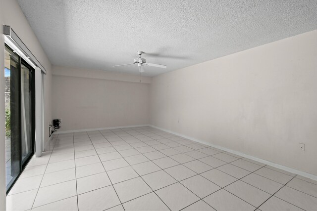 1602 16th Ct Unit 48D, Jupiter, FL 33477 - unfurnished room featuring ceiling fan, a textured ceiling, light tile patterned floors, and baseboards
