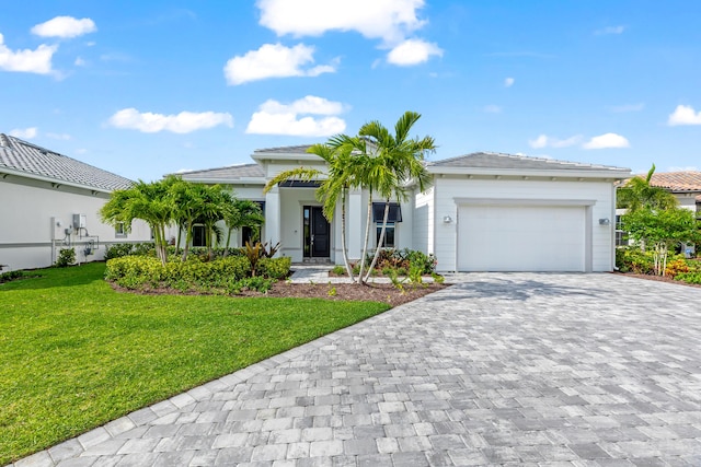 10803 Stellar Cir, Palm Beach Gardens, FL 33412 - view of front of home with decorative driveway, an attached garage, and a front yard