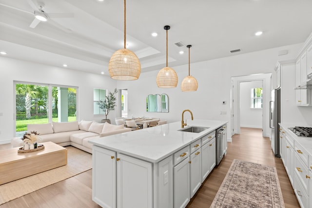10803 Stellar Cir, Palm Beach Gardens, FL 33412 - kitchen with a sink, appliances with stainless steel finishes, recessed lighting, open floor plan, and white cabinets