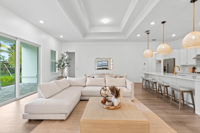 10803 Stellar Cir, Palm Beach Gardens, FL 33412 - living area featuring light wood finished floors, crown molding, recessed lighting, and a raised ceiling