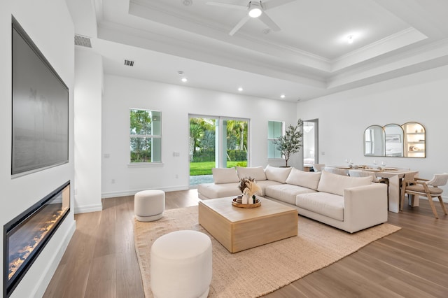 10803 Stellar Cir, Palm Beach Gardens, FL 33412 - living room with a tray ceiling, crown molding, recessed lighting, wood finished floors, and ceiling fan