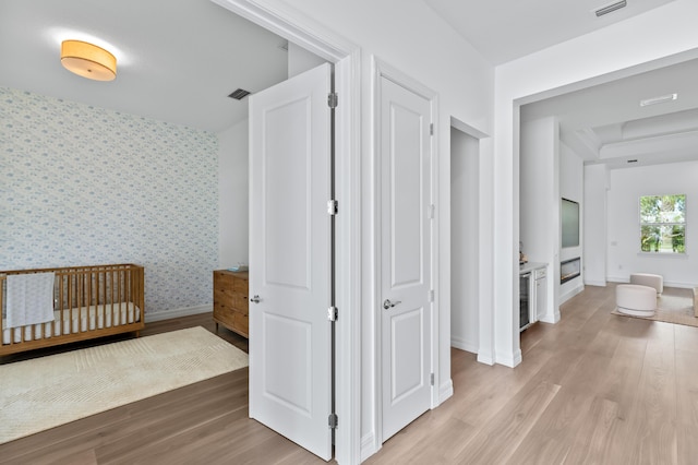 10803 Stellar Cir, Palm Beach Gardens, FL 33412 - hall with light wood-style floors, baseboards, and wallpapered walls