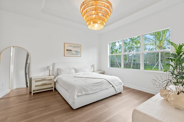 10803 Stellar Cir, Palm Beach Gardens, FL 33412 - bedroom with a raised ceiling, baseboards, wood finished floors, and crown molding