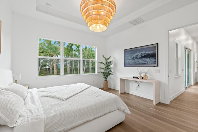 10803 Stellar Cir, Palm Beach Gardens, FL 33412 - bedroom featuring wood finished floors, a raised ceiling, crown molding, and baseboards