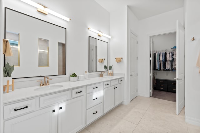 10803 Stellar Cir, Palm Beach Gardens, FL 33412 - bathroom with double vanity, baseboards, a spacious closet, and tile patterned floors