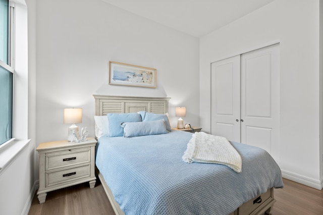 10803 Stellar Cir, Palm Beach Gardens, FL 33412 - bedroom with dark wood-type flooring, a closet, and baseboards