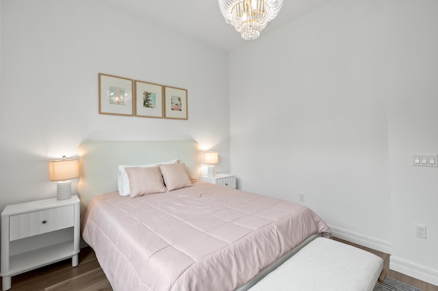 10803 Stellar Cir, Palm Beach Gardens, FL 33412 - bedroom featuring wood finished floors, a chandelier, and baseboards
