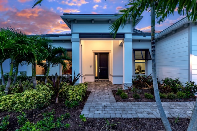 10803 Stellar Cir, Palm Beach Gardens, FL 33412 - doorway to property featuring stucco siding