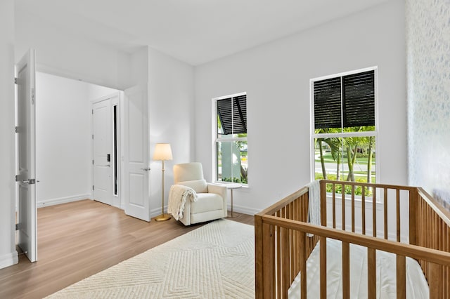 10803 Stellar Cir, Palm Beach Gardens, FL 33412 - bedroom with wood finished floors, multiple windows, a crib, and baseboards