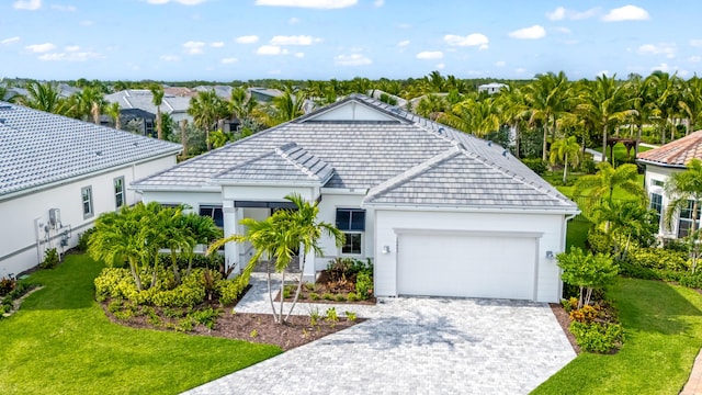 10803 Stellar Cir, Palm Beach Gardens, FL 33412 - view of front of property with an attached garage, a front lawn, stucco siding, and decorative driveway