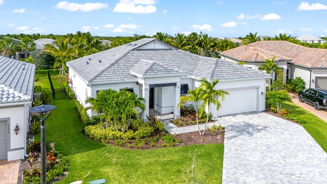 10803 Stellar Cir, Palm Beach Gardens, FL 33412 - view of front facade with a garage, decorative driveway, a tiled roof, and stucco siding