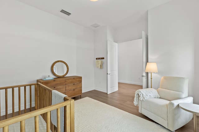10803 Stellar Cir, Palm Beach Gardens, FL 33412 - bedroom with wood finished floors, baseboards, and a crib
