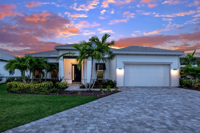 10803 Stellar Cir, Palm Beach Gardens, FL 33412 - view of front facade featuring decorative driveway, an attached garage, and a front lawn