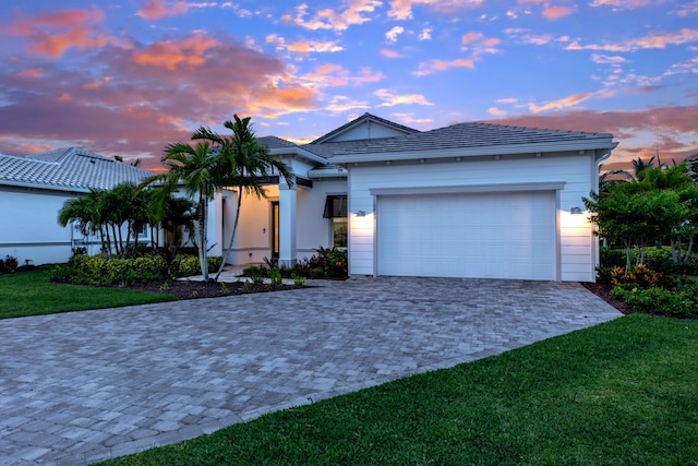 10803 Stellar Cir, Palm Beach Gardens, FL 33412 - ranch-style house with decorative driveway, a garage, and a lawn