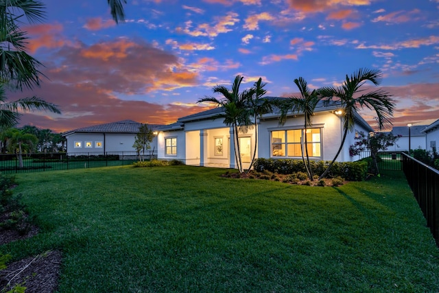 10803 Stellar Cir, Palm Beach Gardens, FL 33412 - back of property at dusk featuring stucco siding