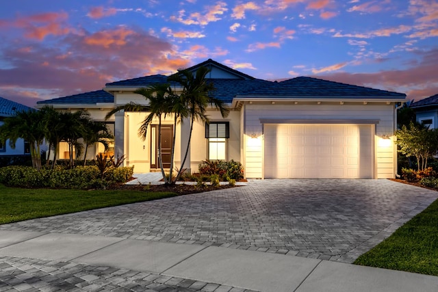 10803 Stellar Cir, Palm Beach Gardens, FL 33412 - ranch-style home featuring decorative driveway and a garage