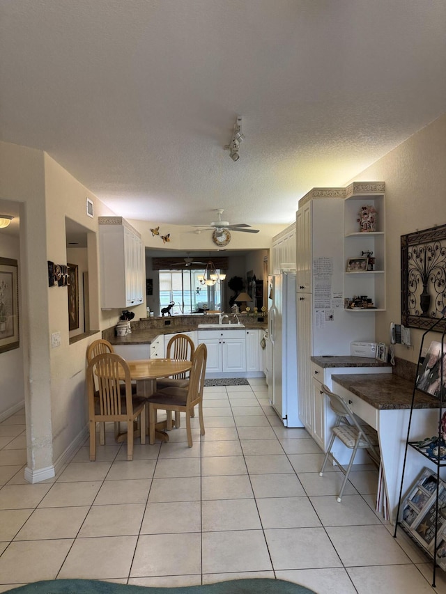 7715 Southampton Ter Unit 102, Tamarac, FL 33321 - dining area featuring light tile patterned flooring, a ceiling fan, and a textured ceiling