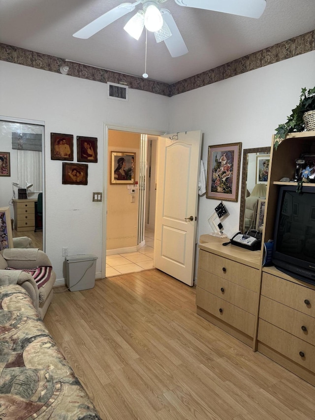 7715 Southampton Ter Unit 102, Tamarac, FL 33321 - bedroom with light wood finished floors, ceiling fan, and a skylight