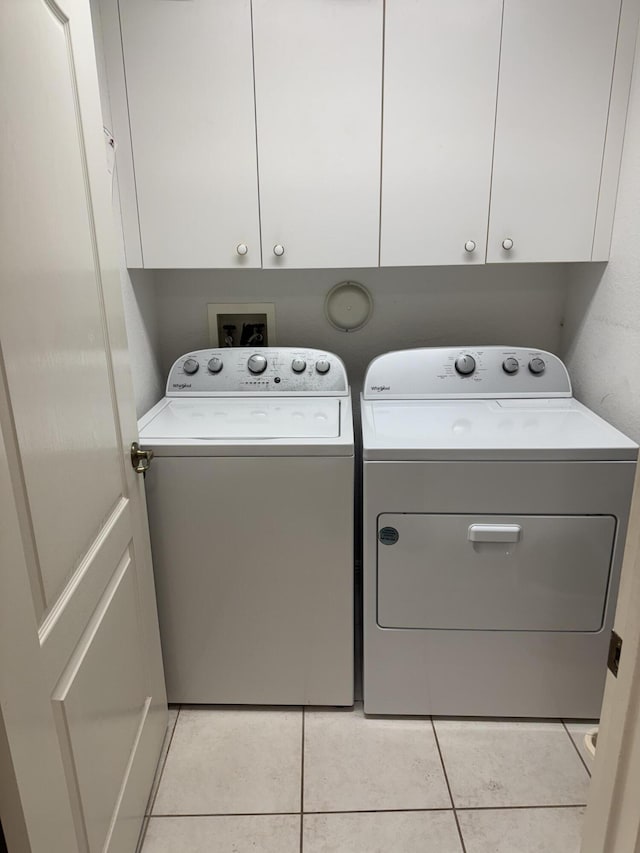 7715 Southampton Ter Unit 102, Tamarac, FL 33321 - laundry room featuring separate washer and dryer, light tile patterned flooring, and cabinet space