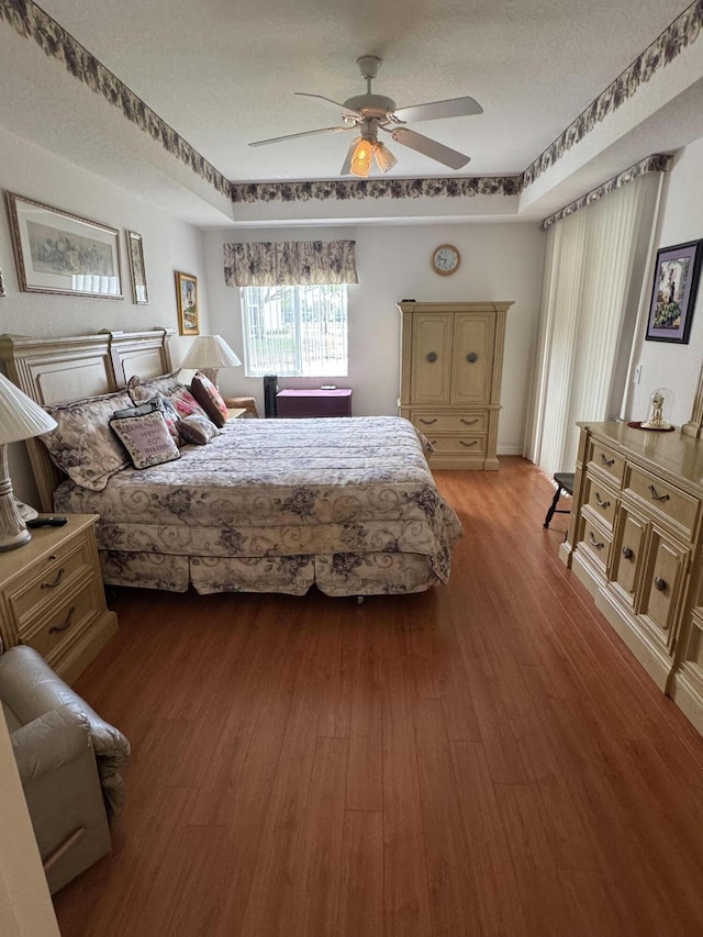 7715 Southampton Ter Unit 102, Tamarac, FL 33321 - bedroom featuring wood finished floors, ceiling fan, and a textured ceiling