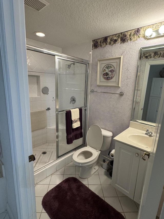 7715 Southampton Ter Unit 102, Tamarac, FL 33321 - bathroom featuring toilet, a textured ceiling, vanity, a shower stall, and tile patterned flooring