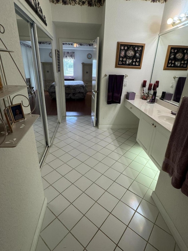7715 Southampton Ter Unit 102, Tamarac, FL 33321 - ensuite bathroom featuring vanity, tile patterned flooring, and baseboards