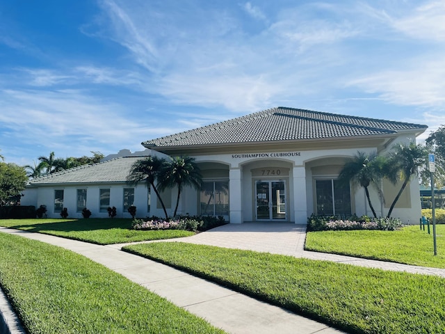 7715 Southampton Ter Unit 102, Tamarac, FL 33321 - back of property with a yard, stucco siding, a tiled roof, and french doors