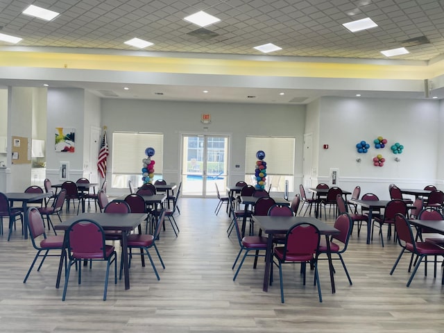 7715 Southampton Ter Unit 102, Tamarac, FL 33321 - dining space with light wood-style floors, a high ceiling, a paneled ceiling, and recessed lighting