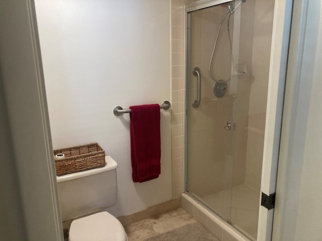 1401 Tidal Pointe Blvd Unit 102, Jupiter, FL 33477 - bathroom featuring a shower stall, toilet, and baseboards
